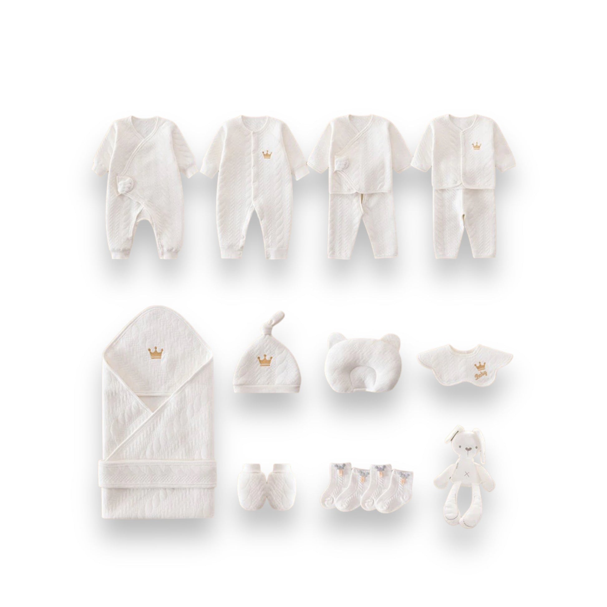 A collection of white newborn baby clothes and accessories, including onesies, hats, booties, a blanket, and a plush toy.